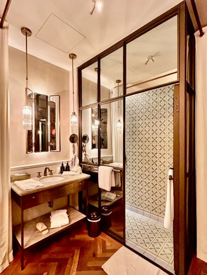 Stylish bathroom featuring patterned walk-in shower and elegant finishes