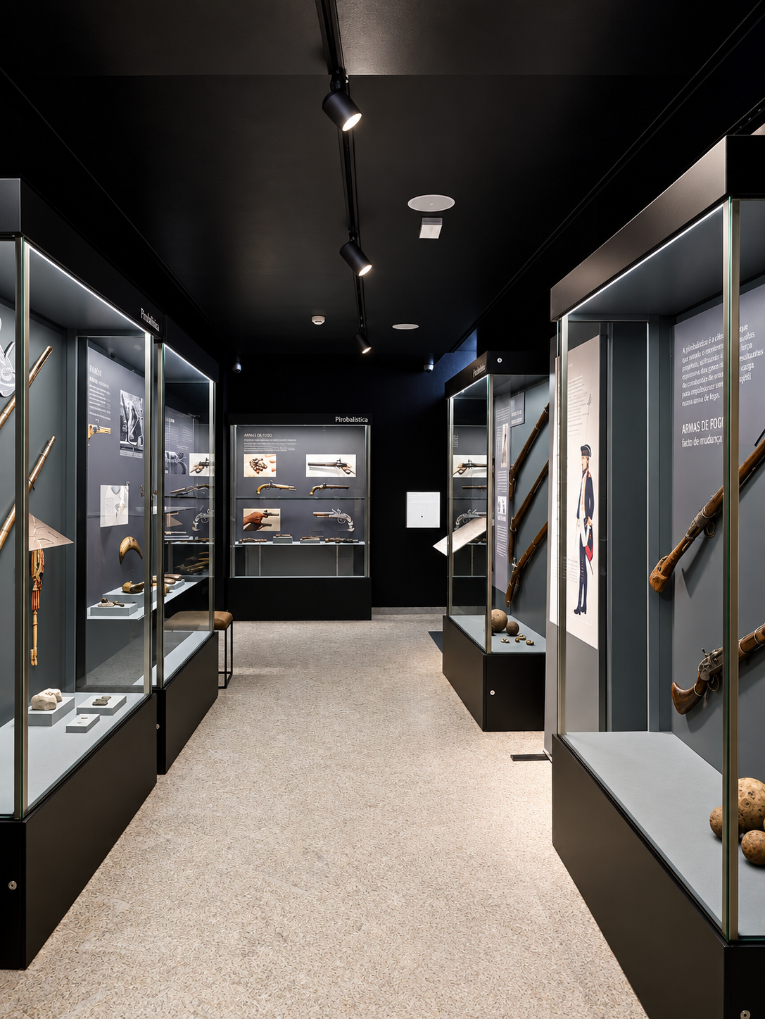 Museum gallery displaying historic artifacts and antique weaponry connected to the region's military heritage
