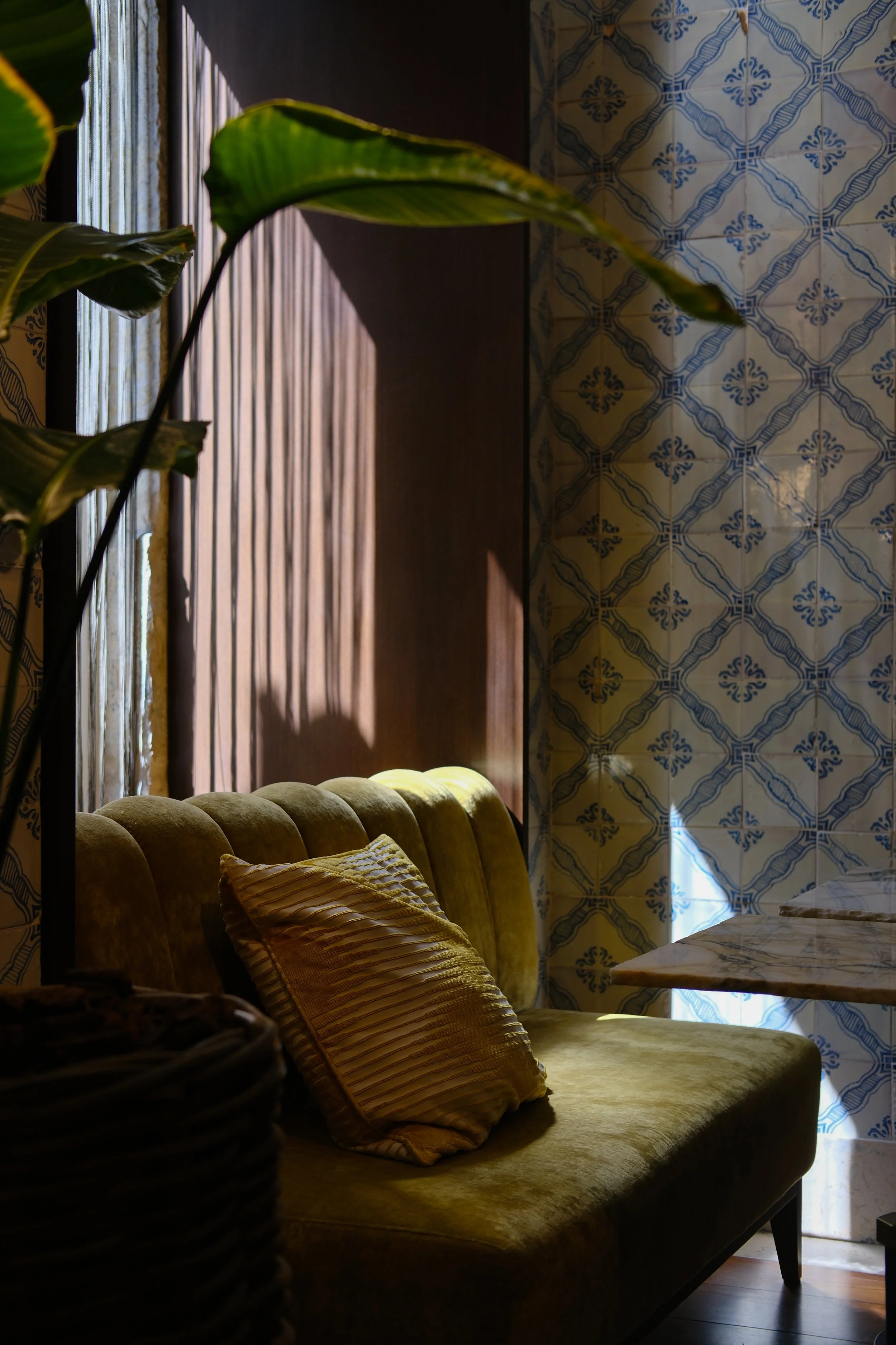 Cozy seating corner combining velvet furnishings with handcrafted Portuguese tiles