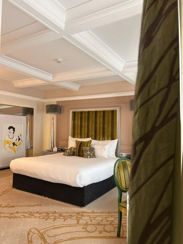 Spacious luxury suite with plush king bed and elegant décor