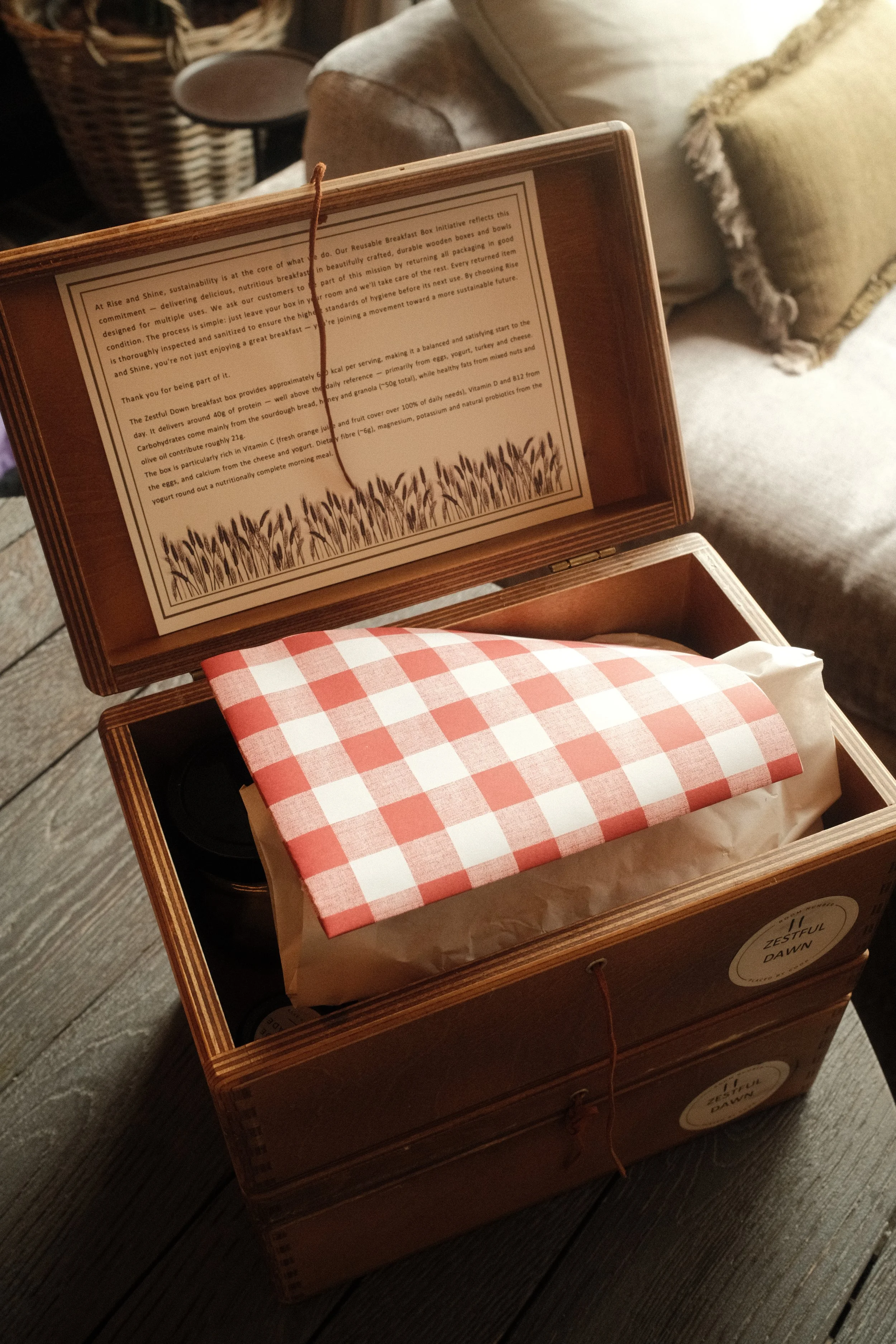 Reusable breakfast box with sustainable packaging presented inside a handcrafted wooden case