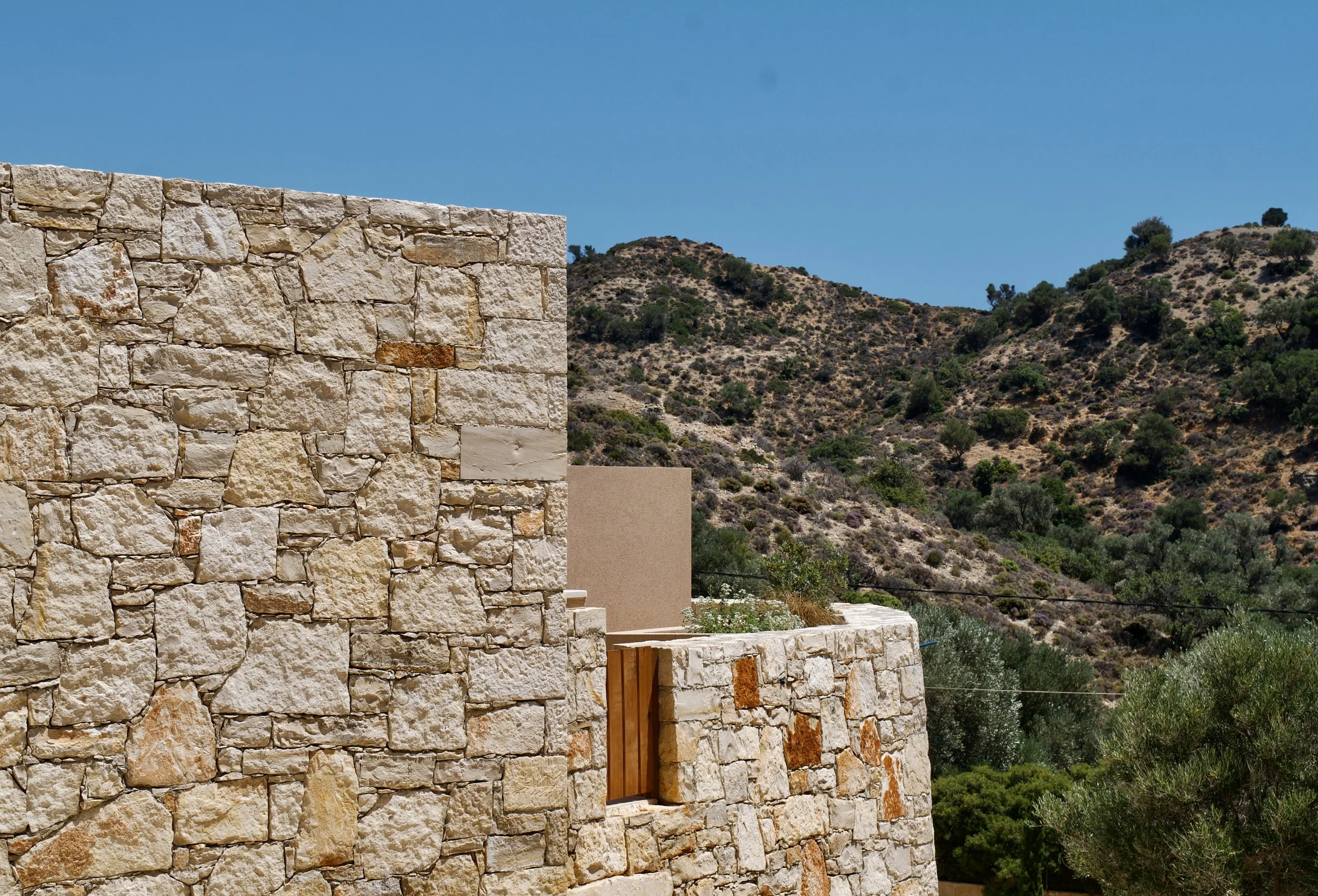 Traditional stone architecture blending seamlessly with the surrounding Mediterranean landscape
