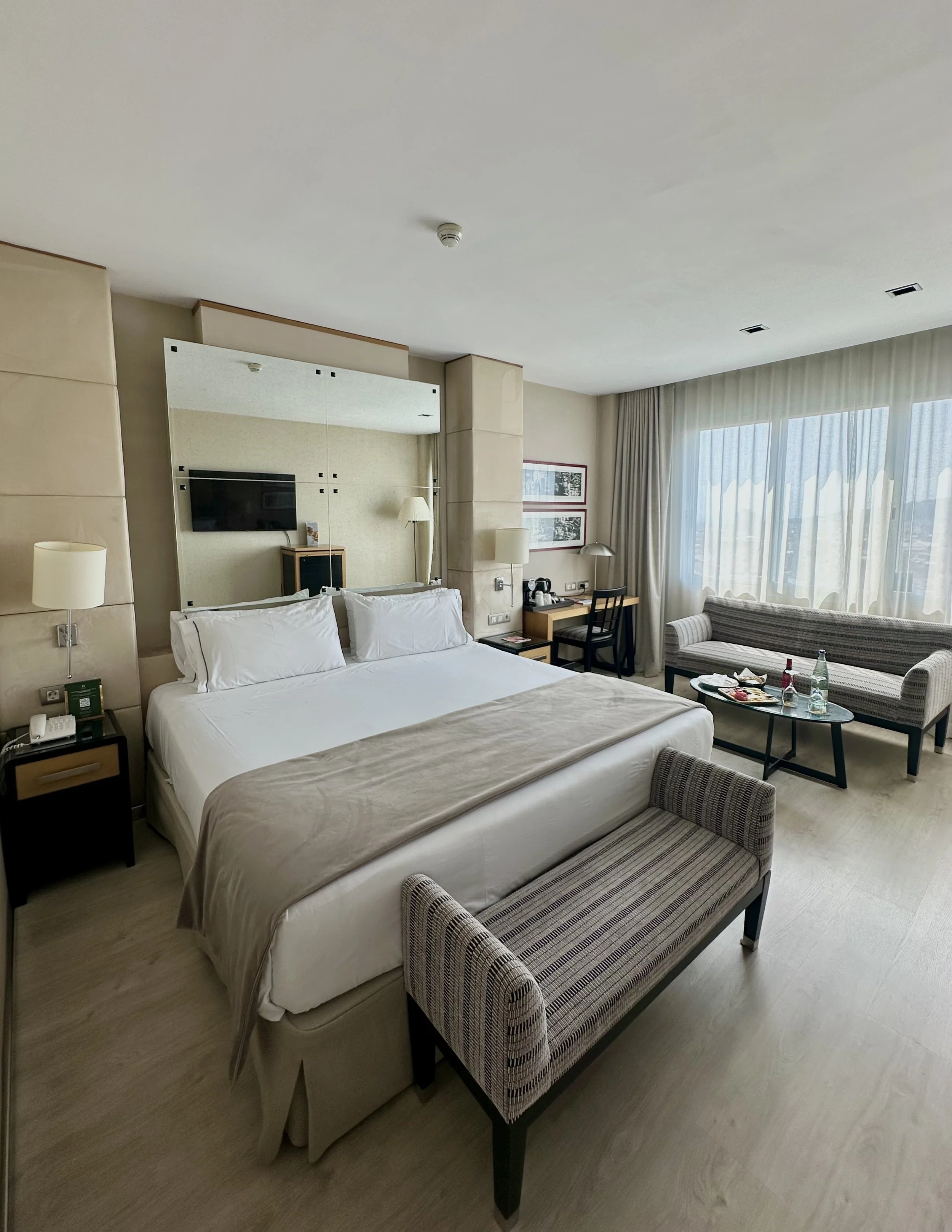 Spacious contemporary guest room with king bed and comfortable seating area
