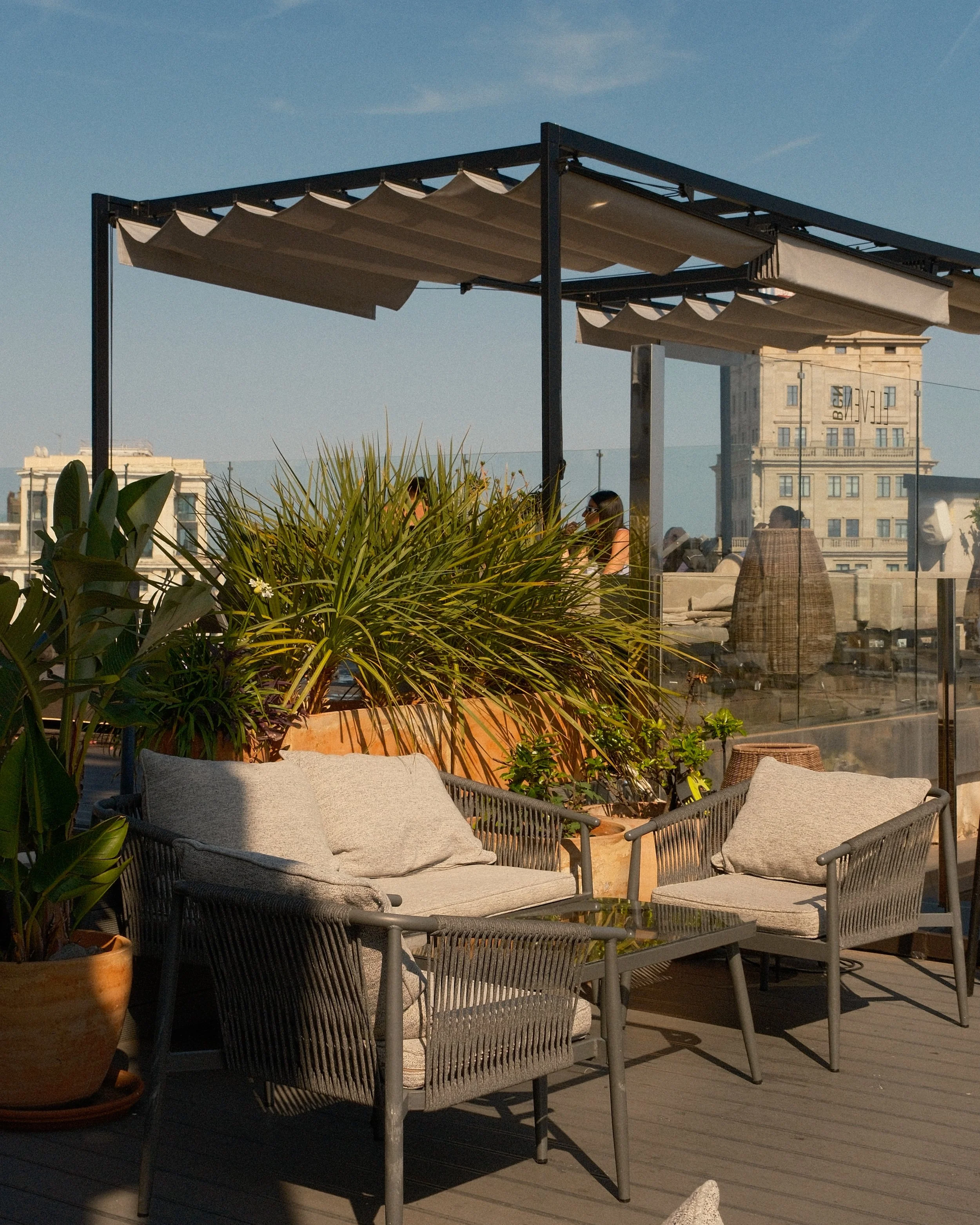Stylish rooftop terrace with lounge seating and panoramic Barcelona views
