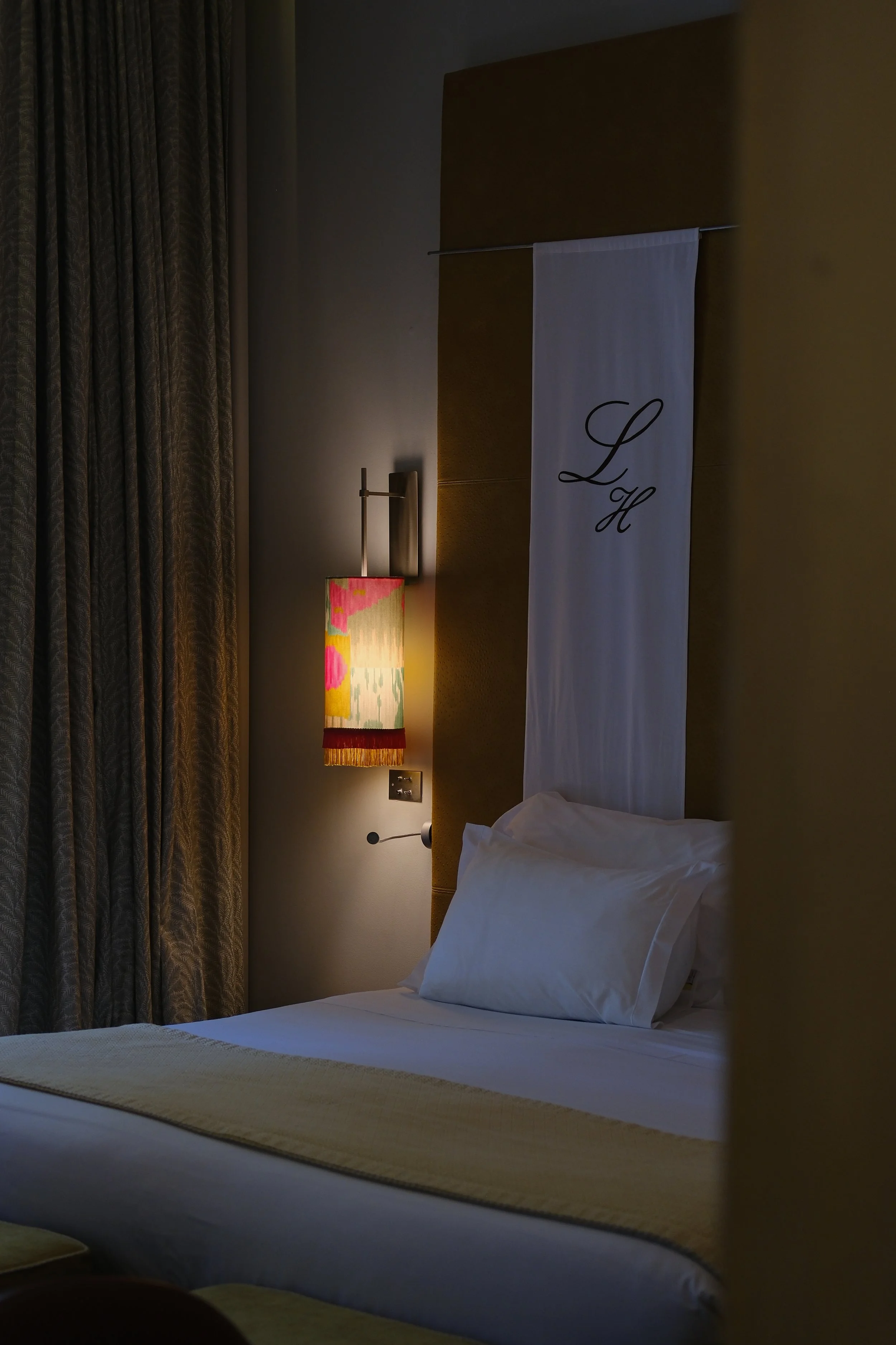 Peaceful guest room featuring crisp linens and refined contemporary details