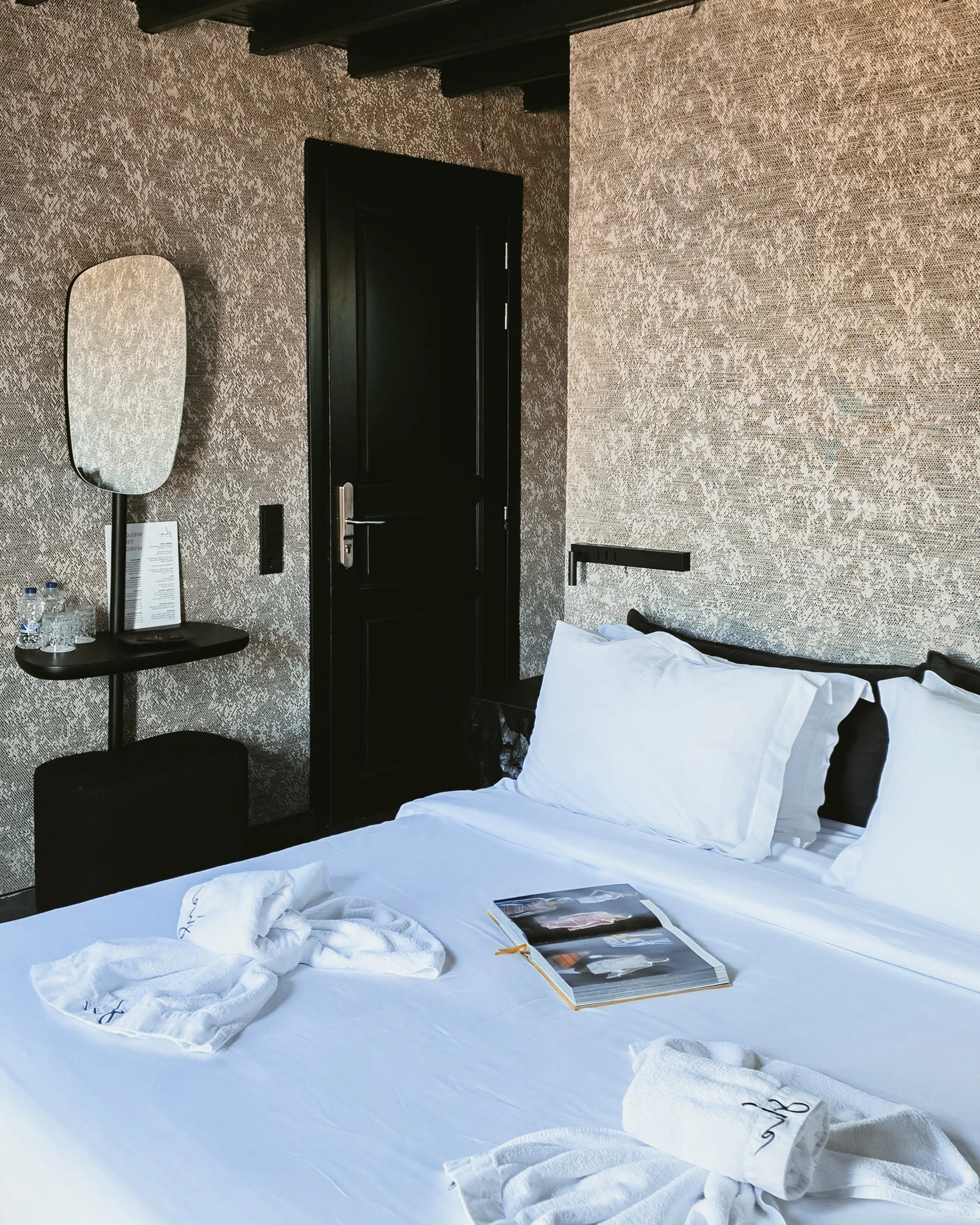 Minimalist boutique bedroom featuring elegant interiors, crisp linens, and contemporary Cycladic design