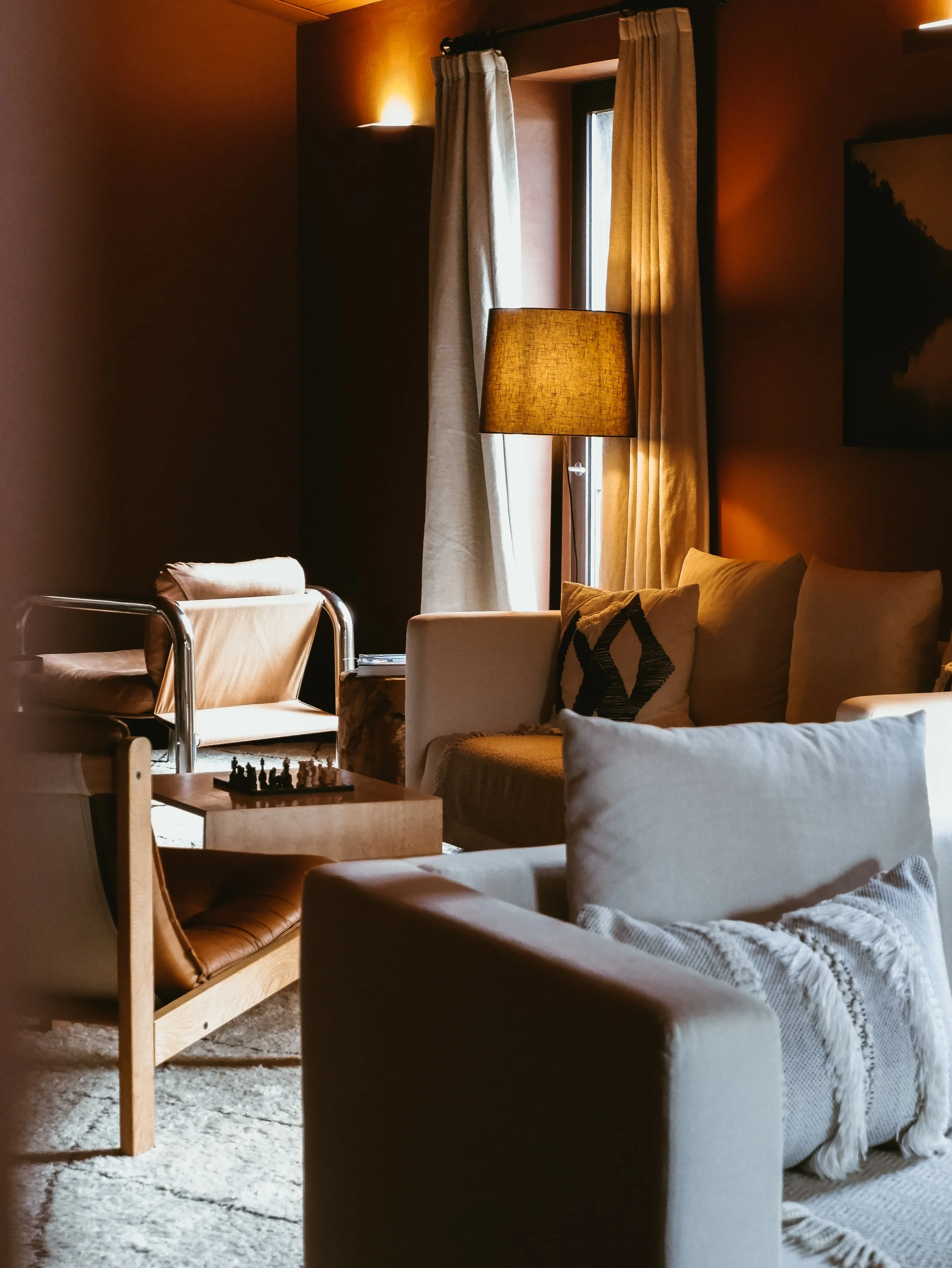 Warm-toned living space with designer furniture and soft lighting, blending comfort and modern elegance, Octant Douro – Castelo de Paiva, Portugal.