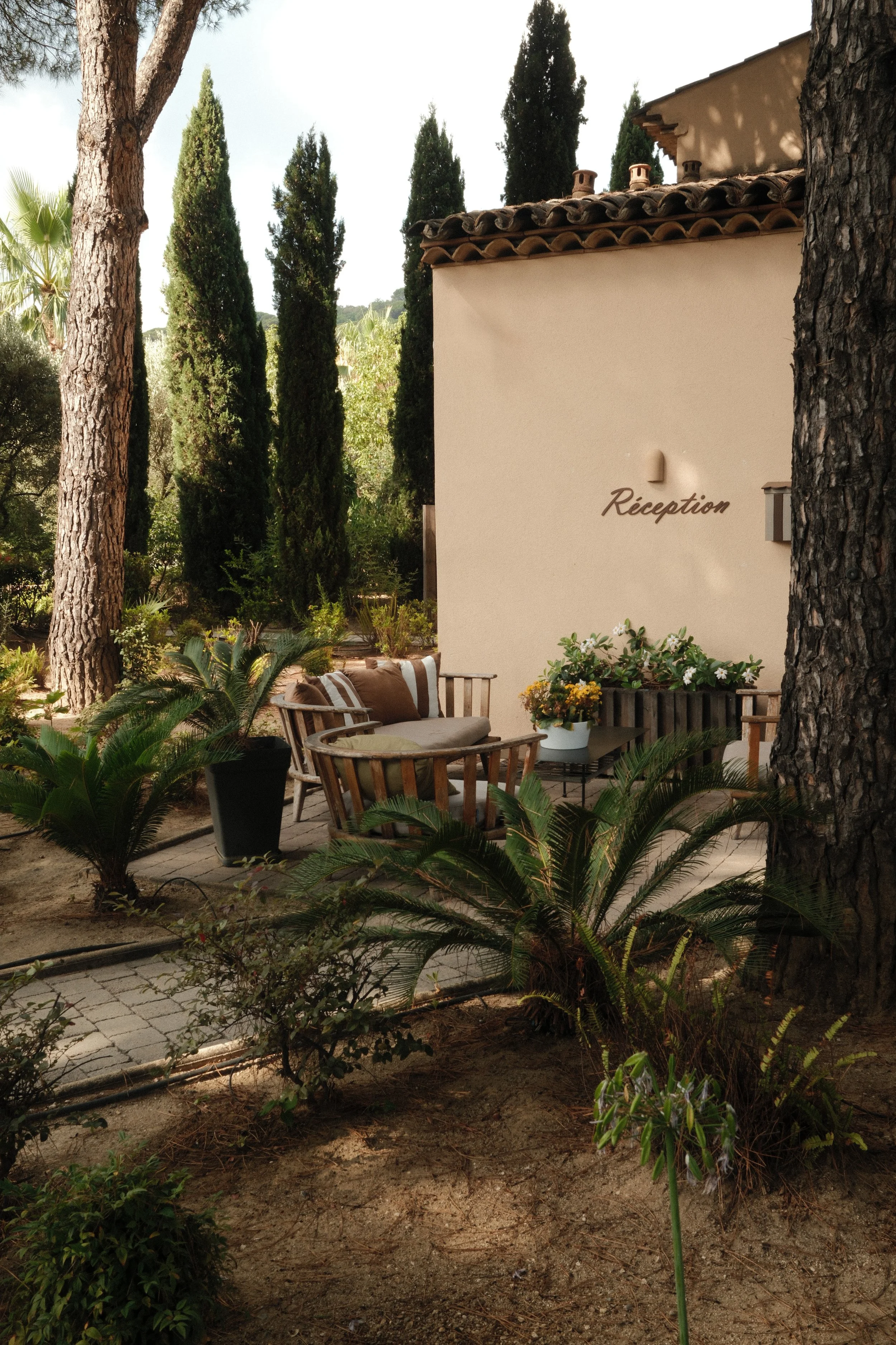Garden reception nestled among pine trees and Mediterranean landscaping