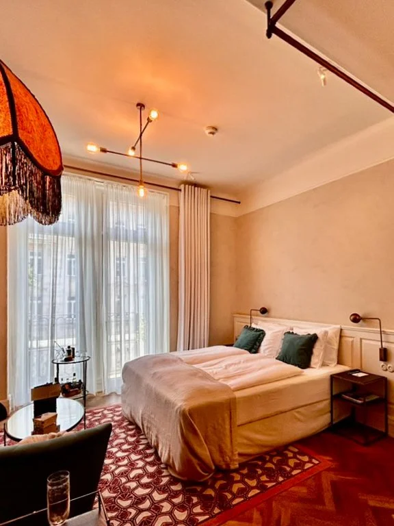 Warm and inviting guest room with vintage-inspired design and balcony doors
