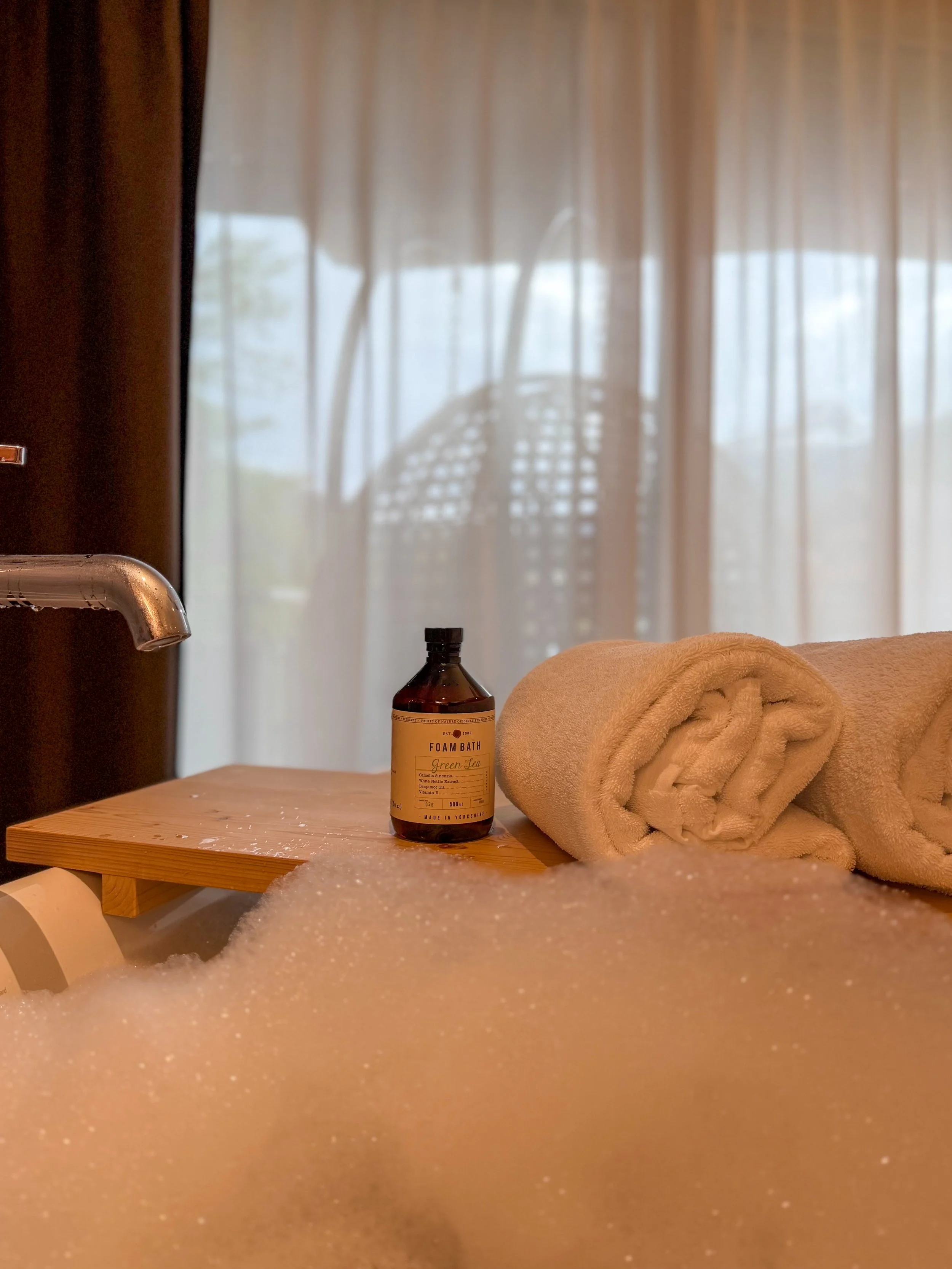Luxury bubble bath with premium bath products creating a calming spa experience in an Alpine suite