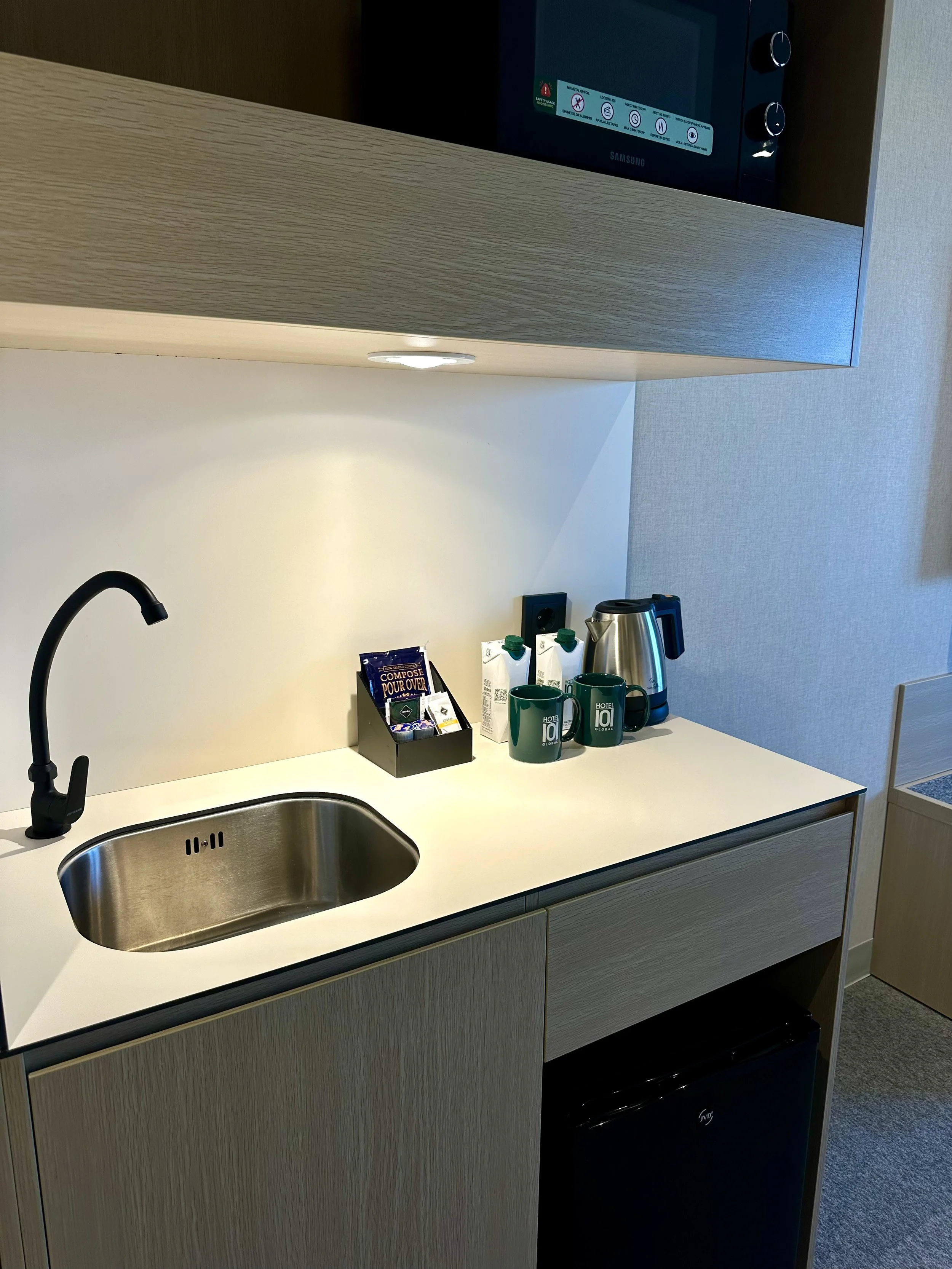 Modern in-room kitchenette with coffee station and functional contemporary design
