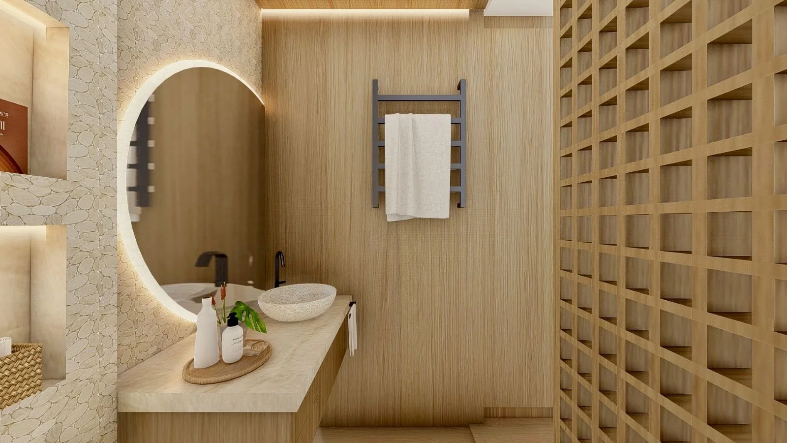 Bagno della suite con lavabo da appoggio, grande specchio circolare retroilluminato e rivestimenti materici chiari. Legno e pietra si combinano per creare un ambiente caldo e contemporaneo.