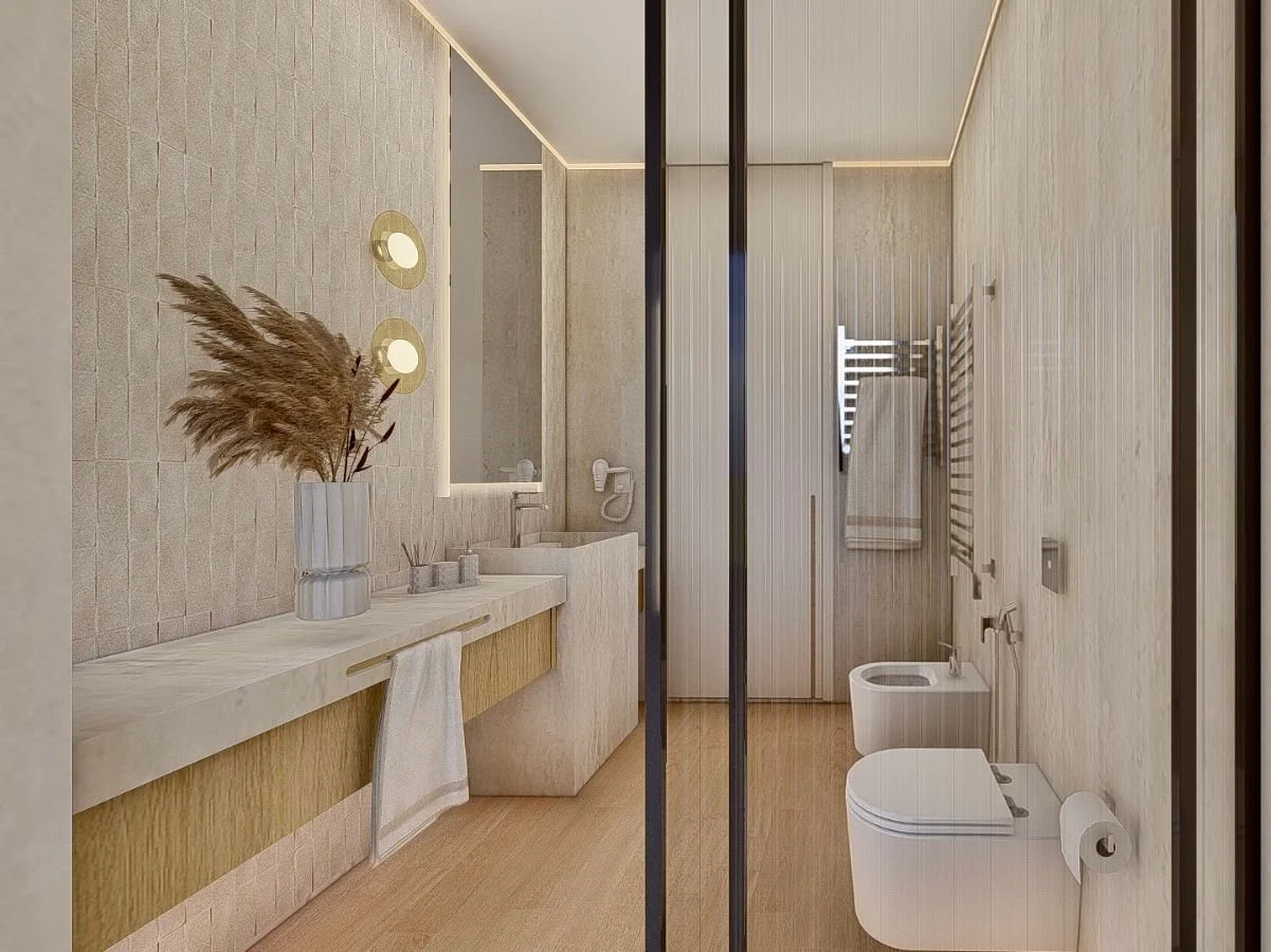 Bagno moderno con pareti beige, lavabo con pianta decorativa, asciugamani su radiatori, bidet e toilette bianchi, porta scorrevole e specchio sopra il lavabo.