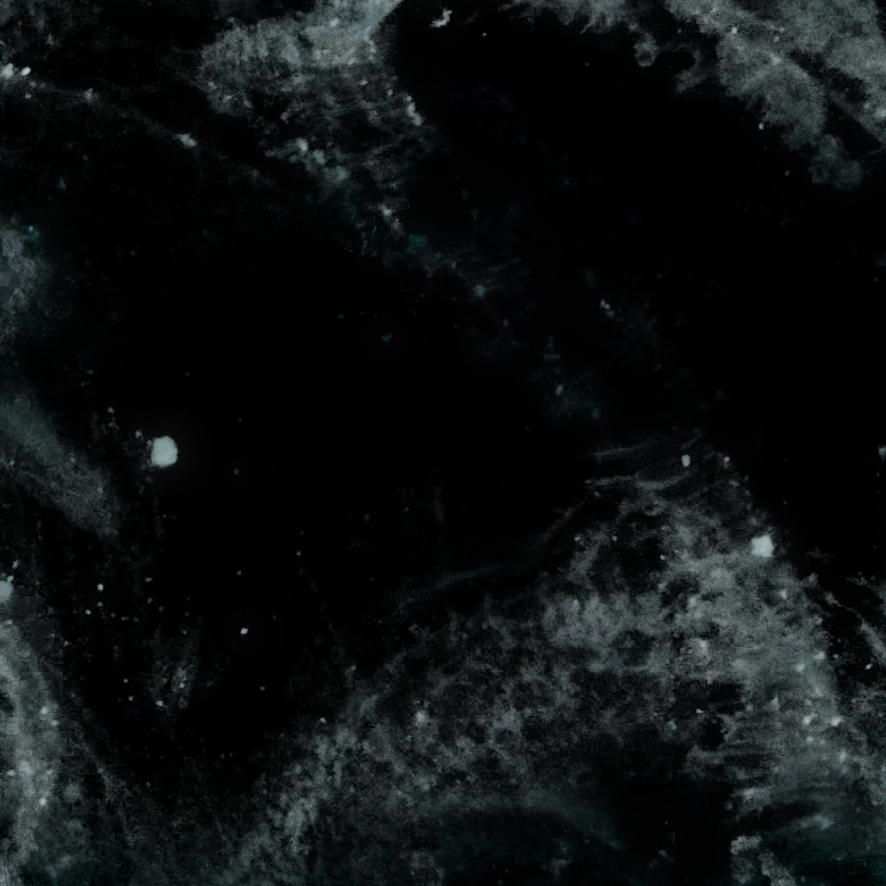 A close-up of a black surface with white spots and streaks. Microscopic photograph of subtle movement of color in water.
