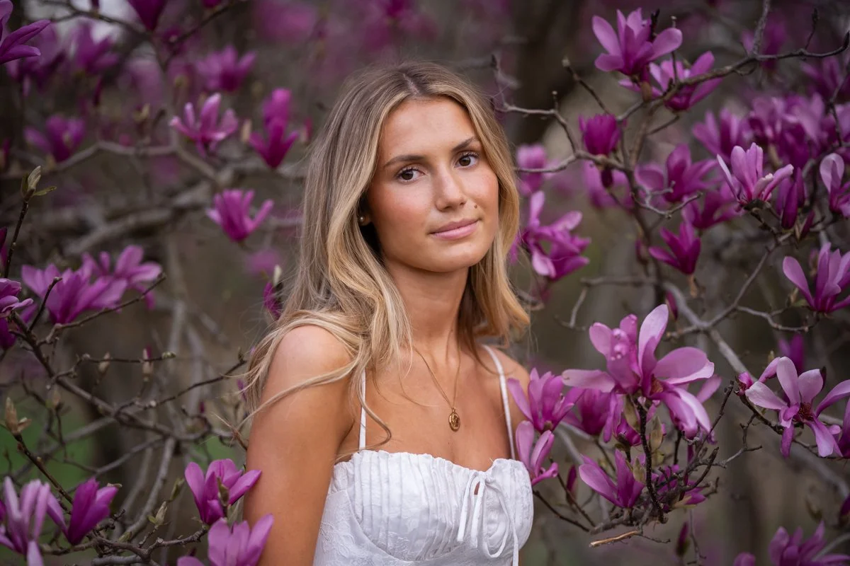 beautiful woman in a bloom of magnolias