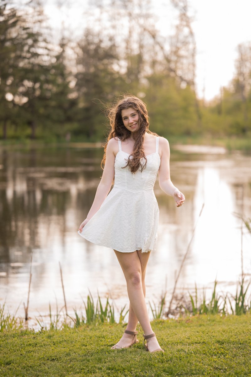 portrait of a teen girl in chicago by a lake at sunset