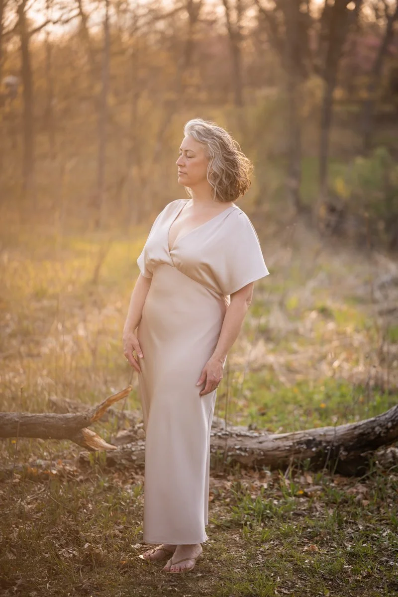 woman with silver hair in repose photographed during the golden hour