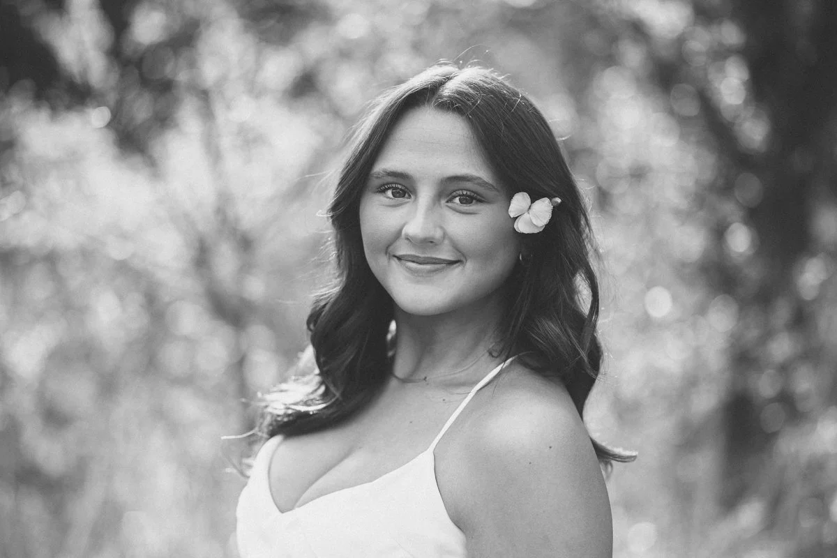 black and white portrait of a girl with a flower in her hair