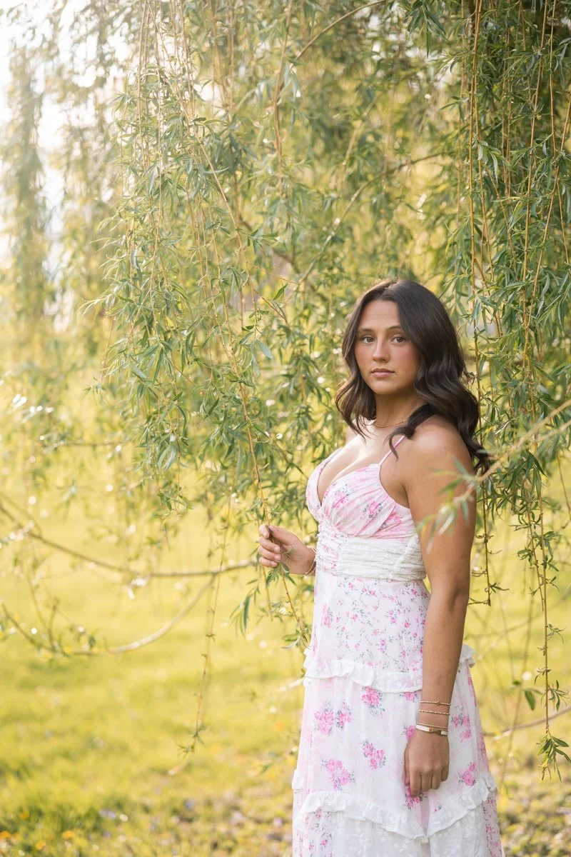 a portrait of a teen in a dress in golden backlight