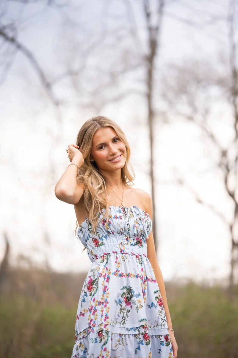 blond young woman in a field for a portrait