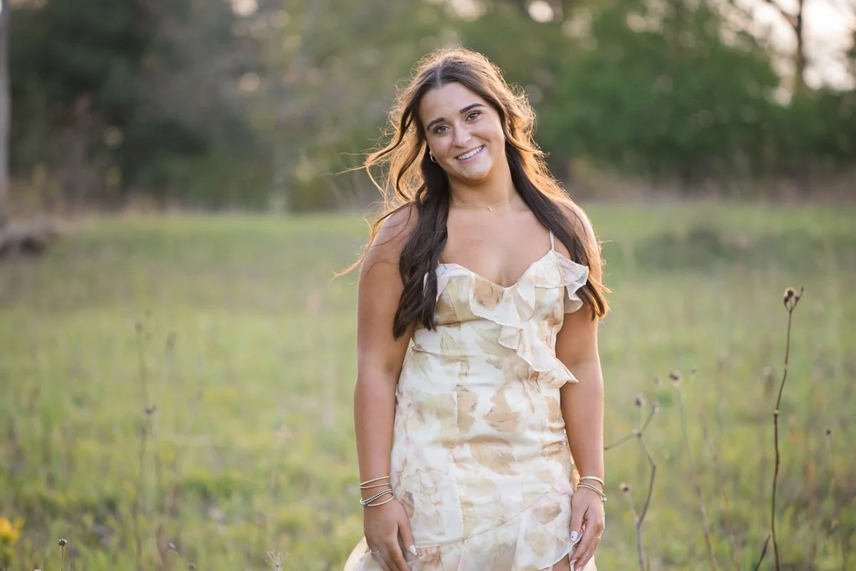 teen portrait in a flowy dress in a field
