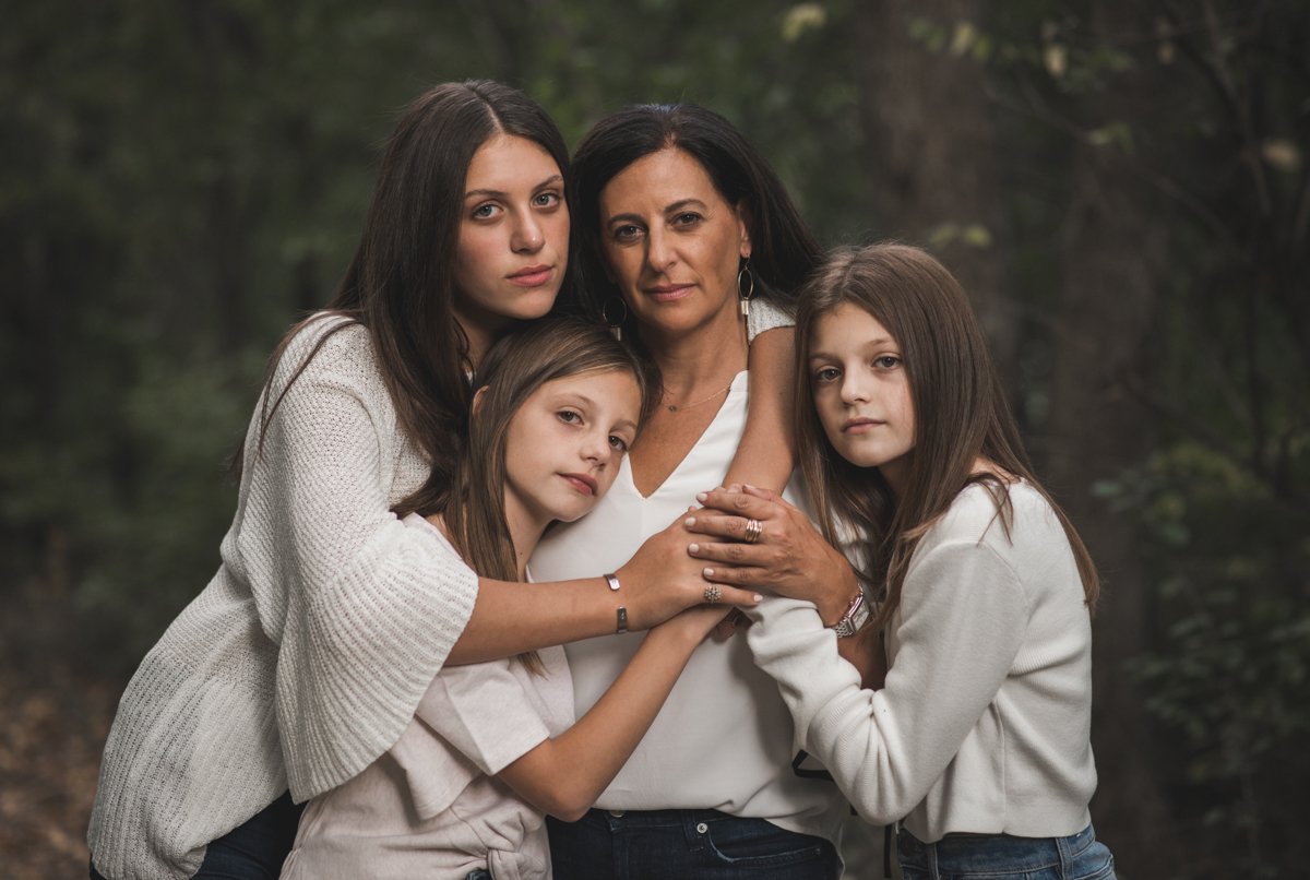 woman in a portrait surrounded by her daughters