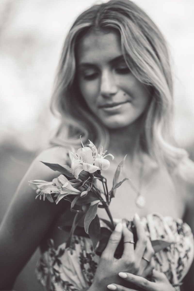 black and white portrait of a woman with a flower