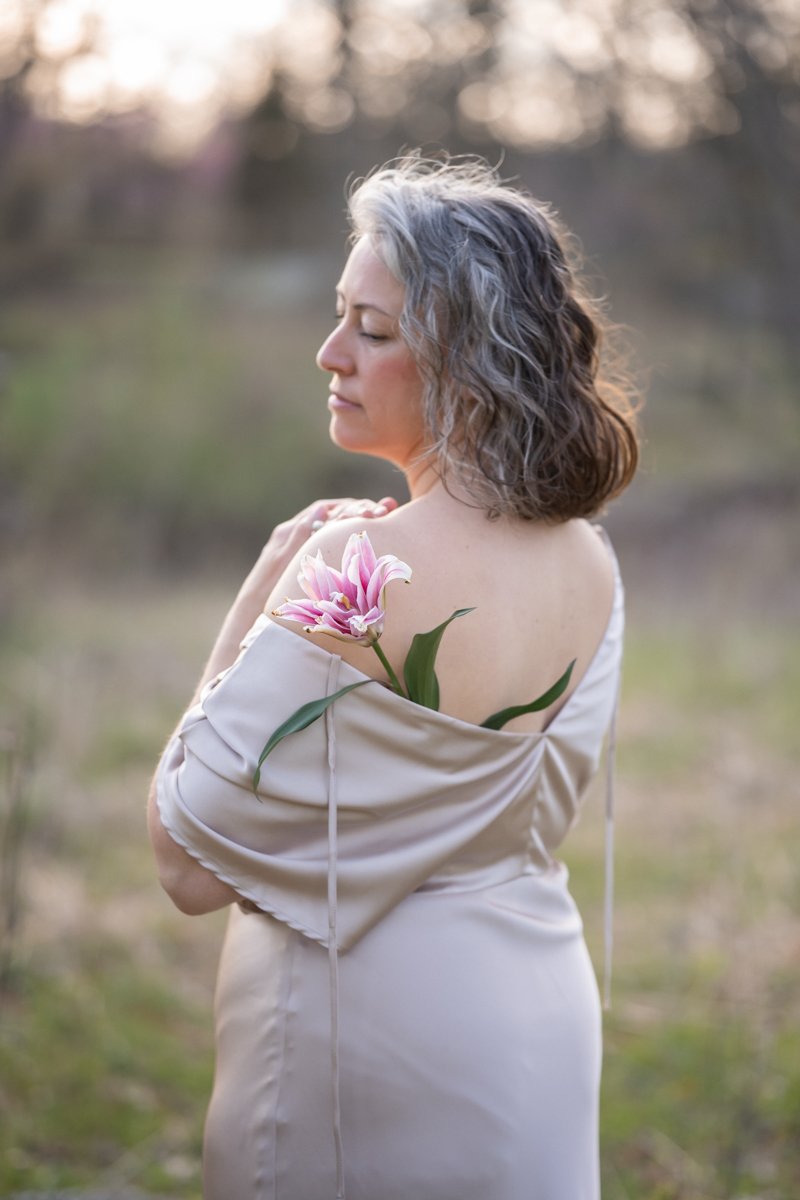 a beautiful woman with silver hair in a field for a portrait