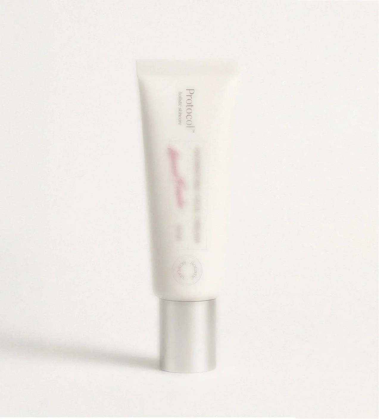 A white tube of skincare product labeled 'Protoco' standing upright on a white surface.