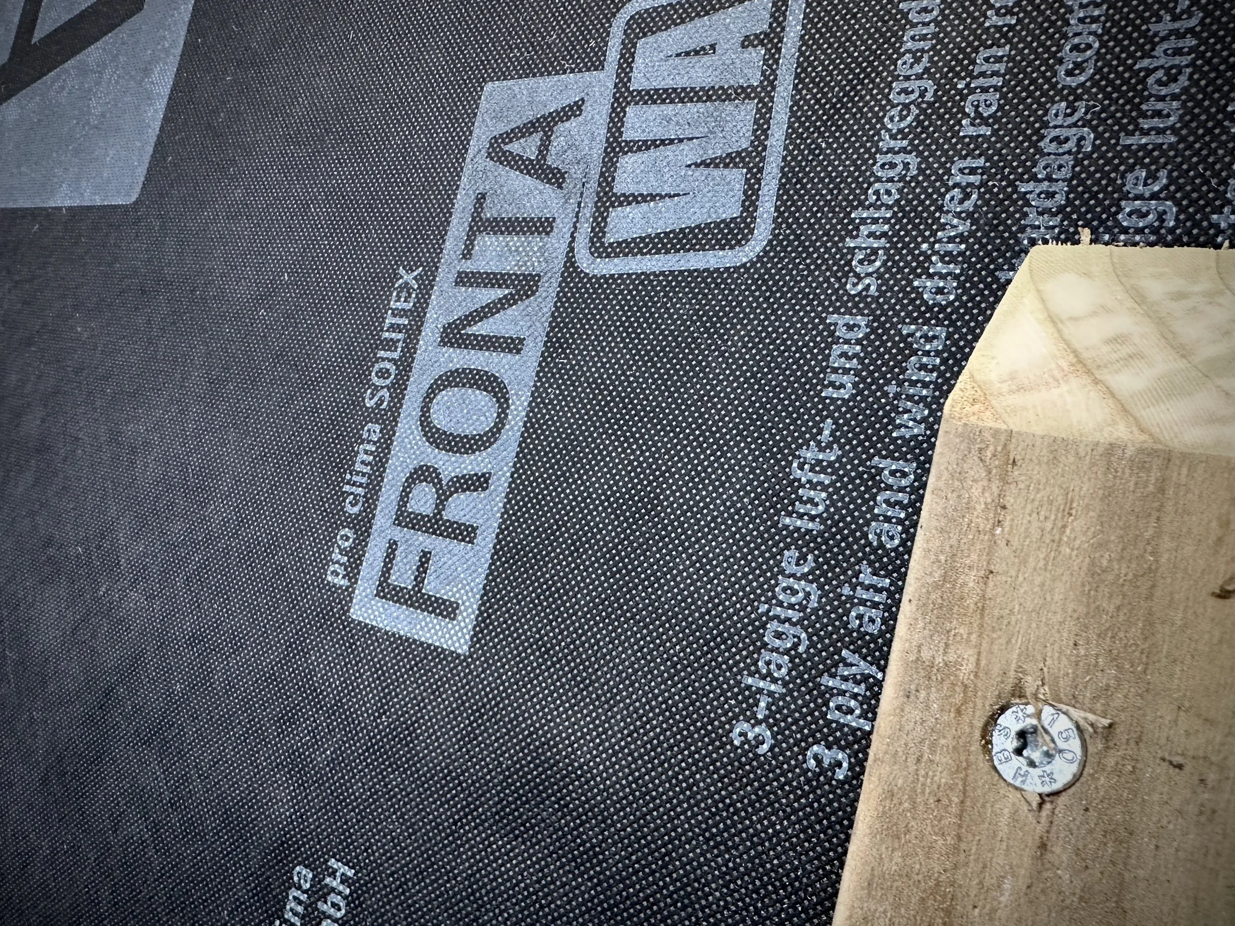 Breathable, weatherproof membrane detail protecting a timber tiny home wall while allowing moisture to escape.