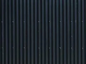 Fibre-cement profiled sheet cladding used on a tiny home façade.