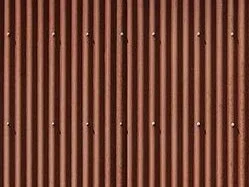 Corten steel façade on a tiny or micro home, showing protective rust patina.