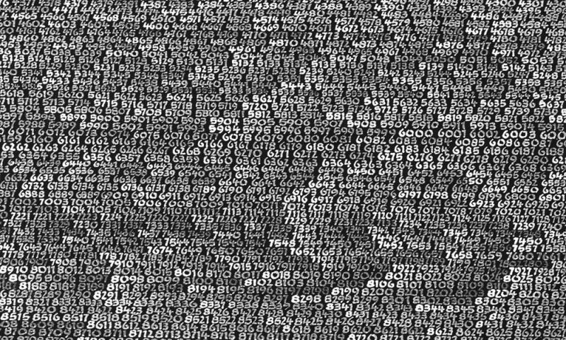 A screen filled with dense white numerical code on a black background, with some areas slightly blurred.