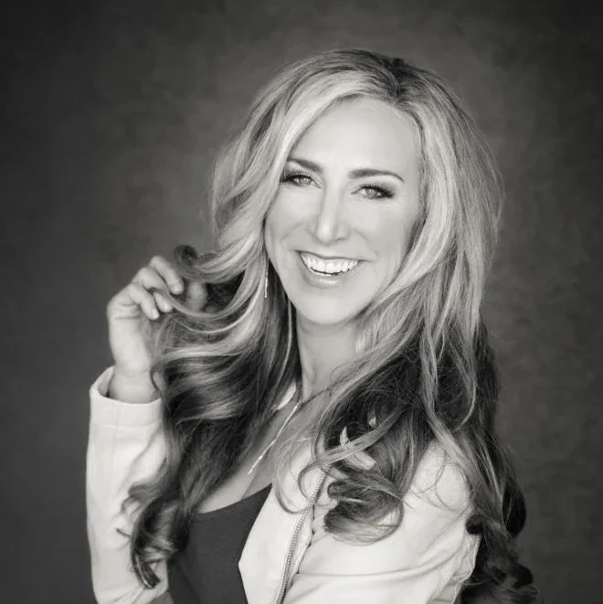 Black and white professional headshot of Lisa Fierer smiling at the camera.