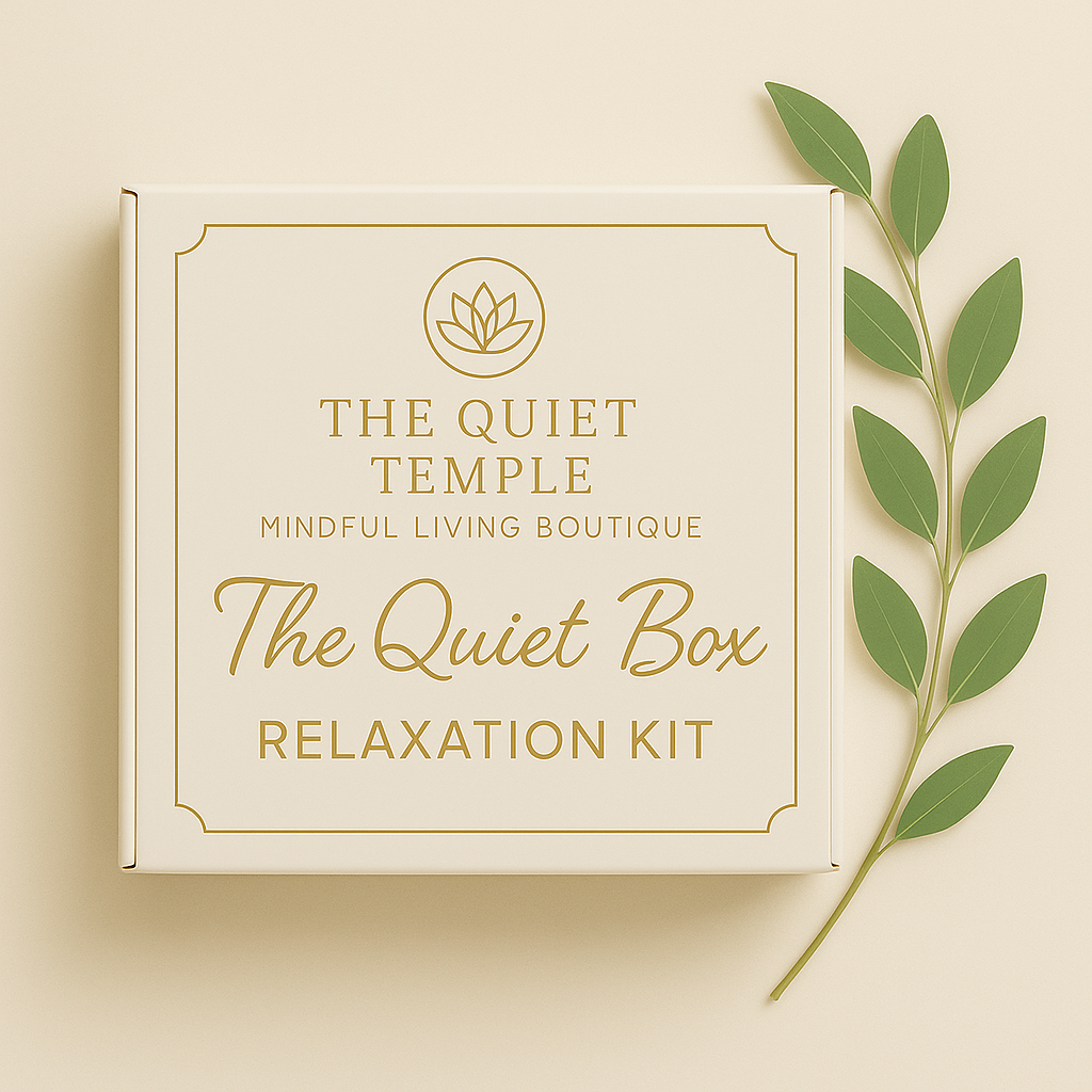 A beige box labeled 'The Quiet Box Relaxation Kit' with gold text and a lotus flower logo, placed next to a green leafy branch.