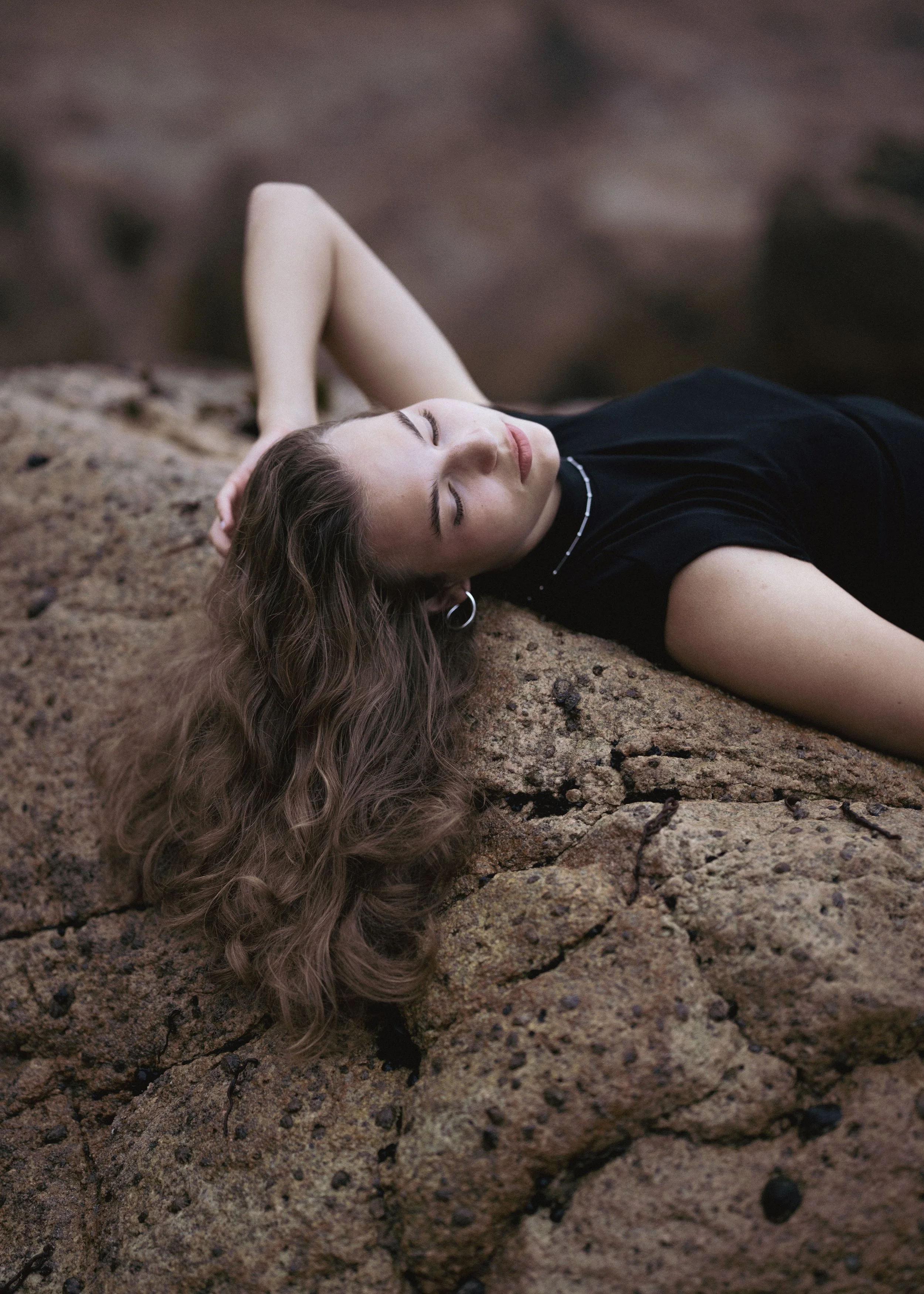 woman-lying-on-rocks-portrait.jpg