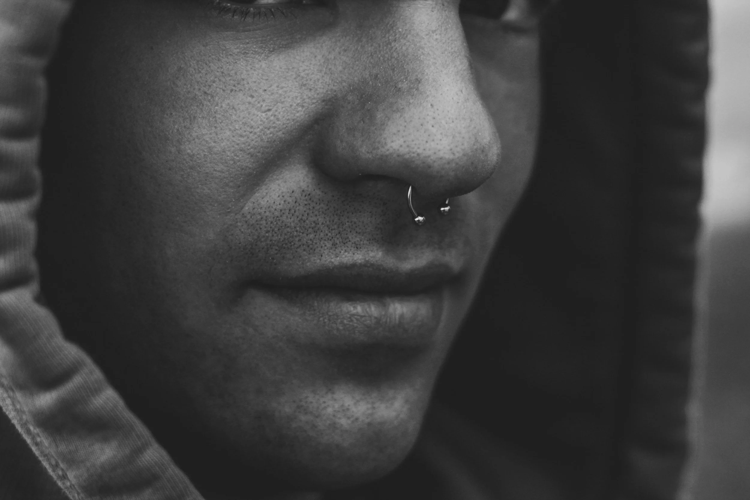 Close-up of a person's face with a nose ring but we do multiple piercings at immortal art studio in Carlisle