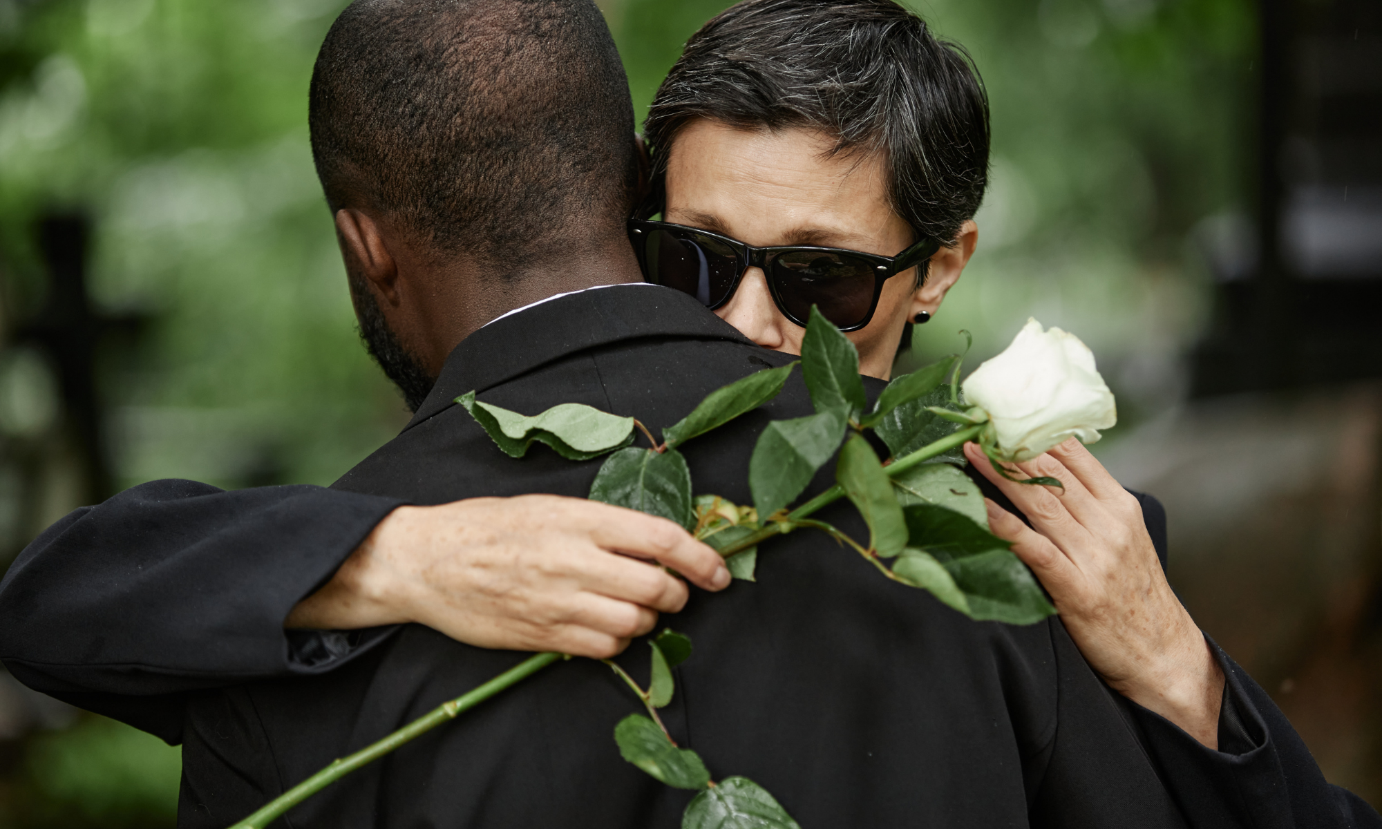 Grieving family hugging after a fatal car accident