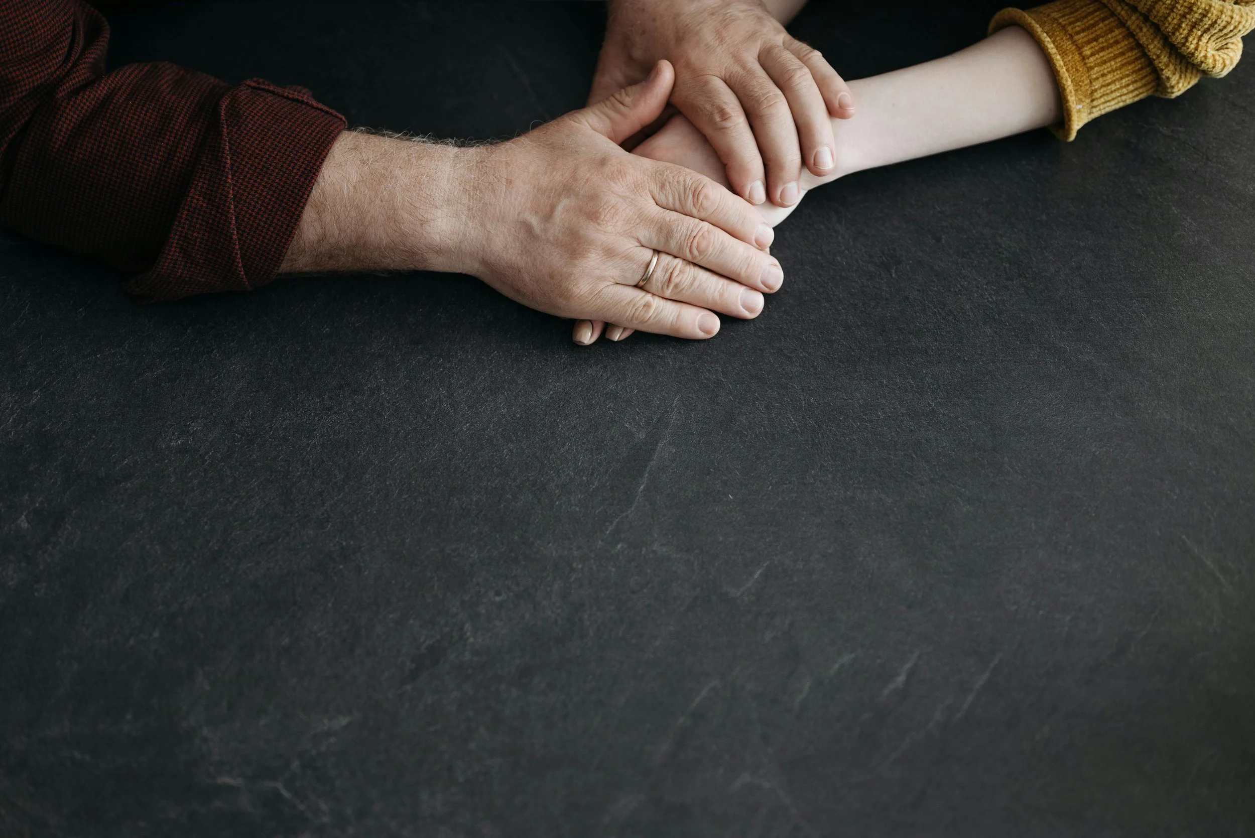Hands offering comfort and support after a wrongful death in Phoenix