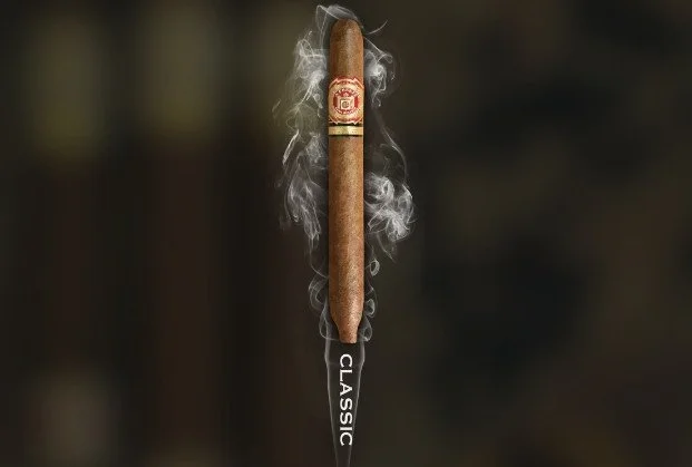 A cigar with smoke rising from the lit end, branded with a red and gold band, positioned vertically over the word 'CLASSIC.'