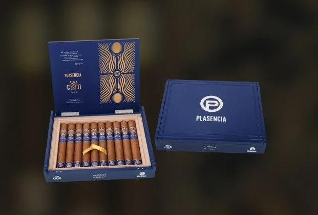 An open blue box of Plasencia Alma Cielo cigars shows ten cigars inside with a blue and gold band, next to a closed blue box with the Plasencia logo.