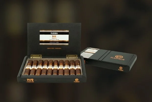 An open black box with 14 cigars inside, labeled 'Plasencia,' next to a closed box with the same branding.