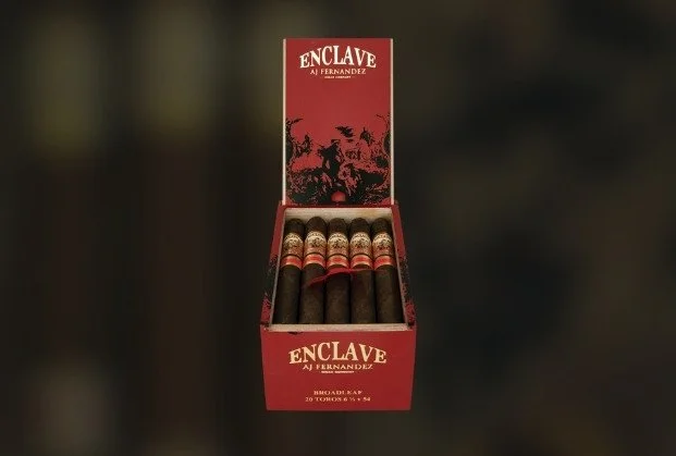 Open red box of Enclave AJ Fernandez cigars showing five cigars inside.