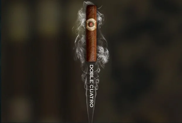 A cigar with a band, surrounded by smoke, positioned above the words 'Doble Cuatro' written vertically.