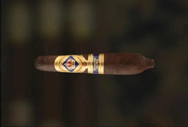A cigar with a decorative band and a dark brown wrapper.
