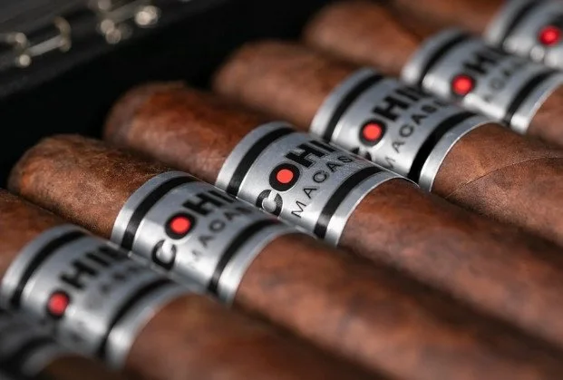 Multiple cigars with branded bands reading 'H. Upmann' lying in a row.