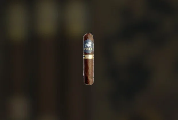 A cigar floating in mid-air against a dark, blurry background.