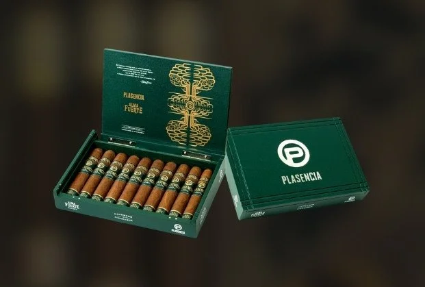 A green cigar box with an open lid displaying cigars inside, and a closed lid box beside it with the brand name 'Plasencia' and logo.