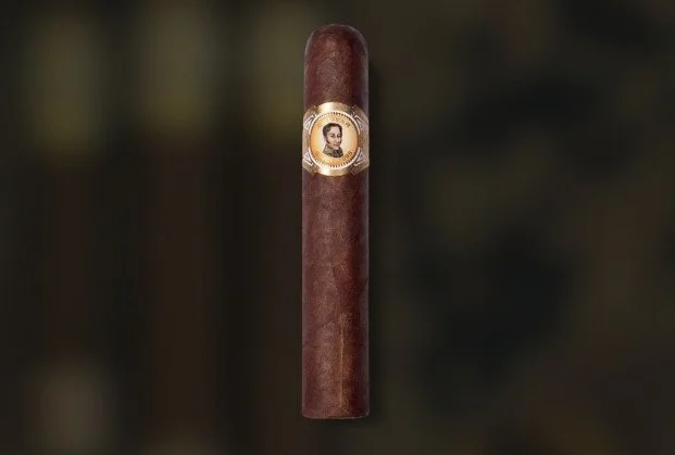 A brown cigar with a band featuring a portrait of a man.