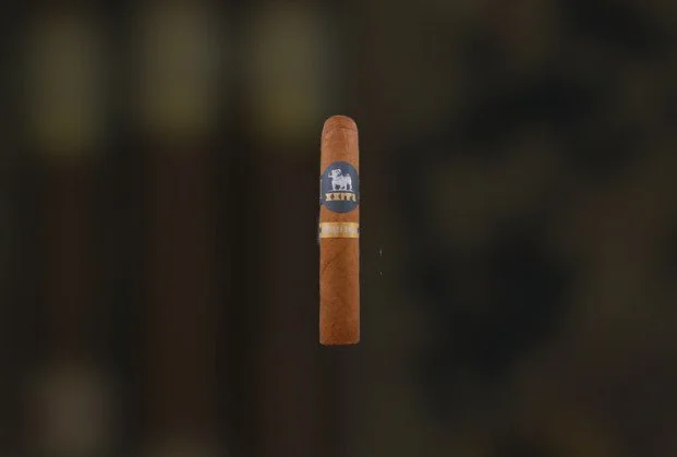 A single cigar with a blue band featuring a white elephant and the words Abeja.